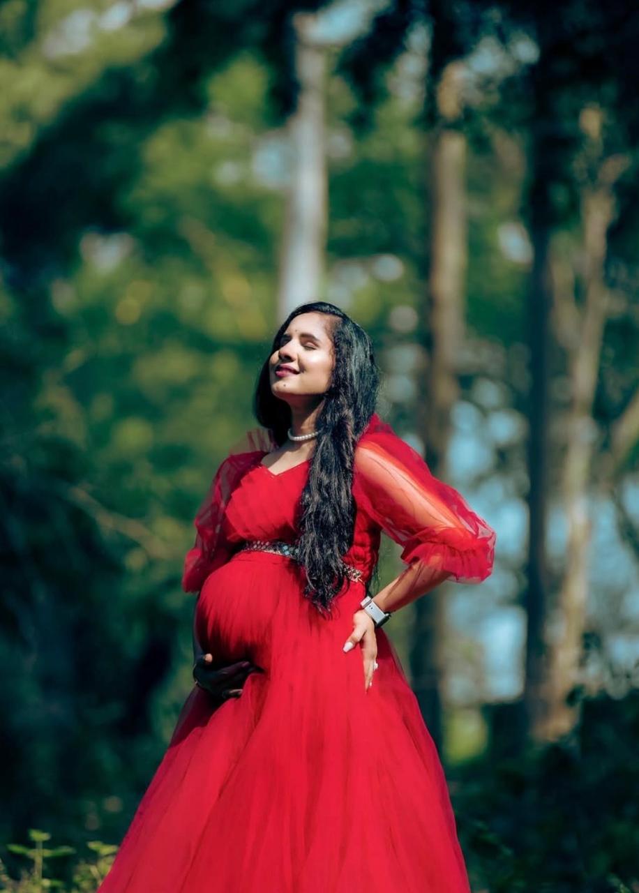 Cute baby photoshoot styling for Ms. Sheetal in a red dress.